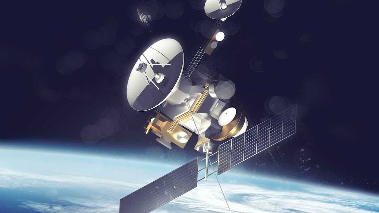 satellite with solar panels deployed over Earth