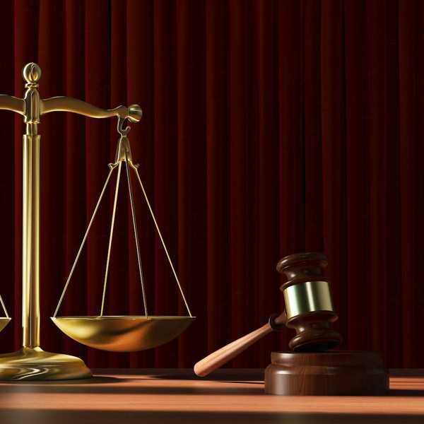 Scales of justice adjacent to a resting judges gavel