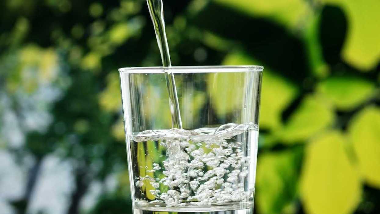 Seemingly clear, pure, water pouring into a water glass