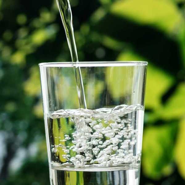 Seemingly clear, pure, water pouring into a water glass