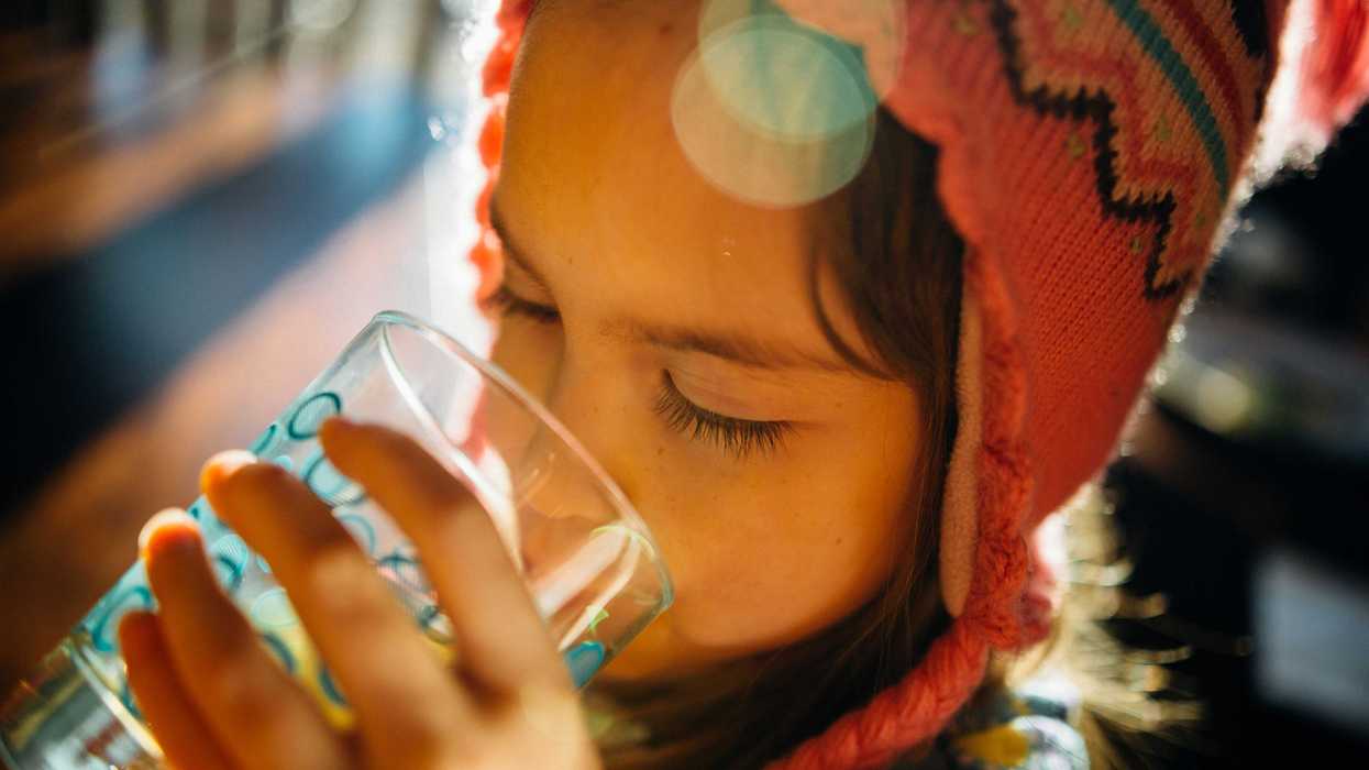 selective focus photography of girl drinking water.