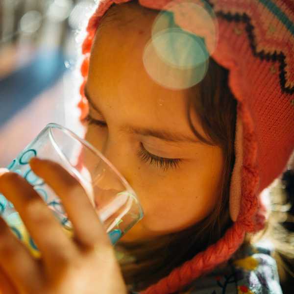 selective focus photography of girl drinking water.