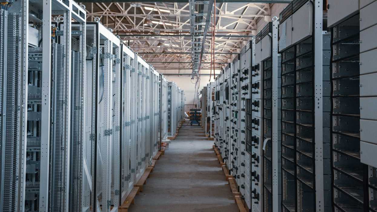 server room aisle with metal equipment racks.