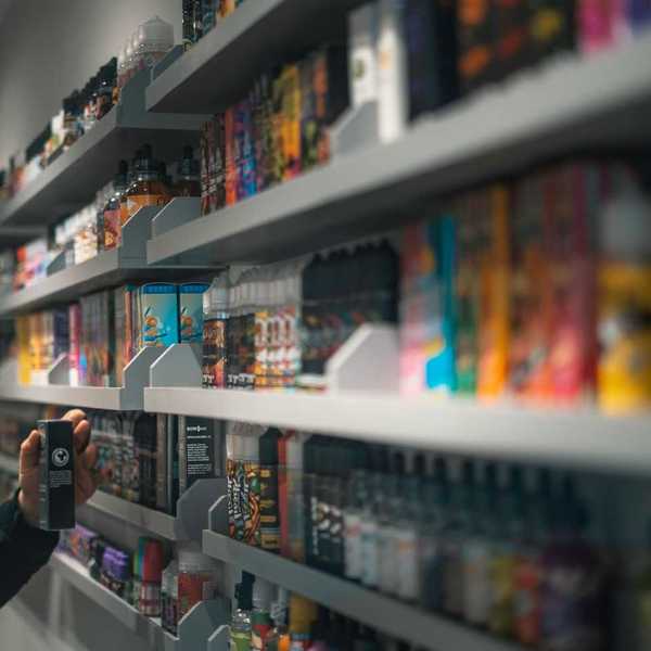 Shelf stocked with various vaping devices and vaping accessories