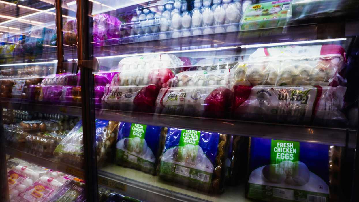 Shelves of plastic packaged food items in a grocery store.