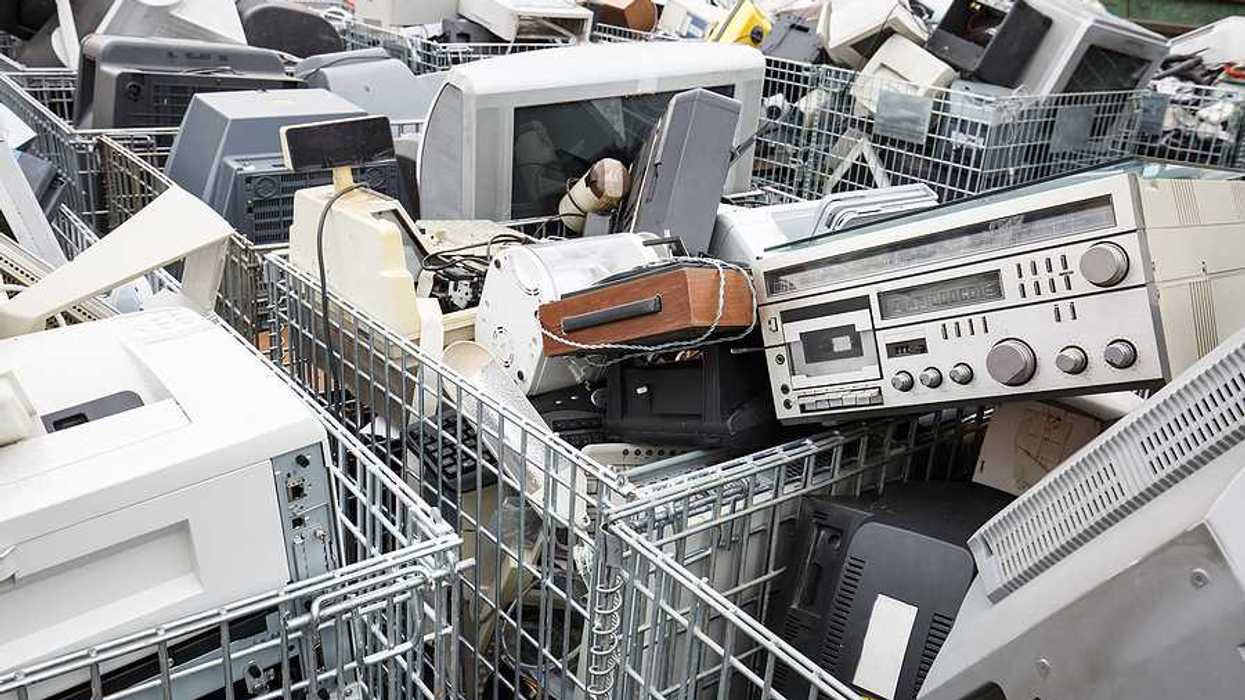 Shopping carts full of electronic waste like old monitors and computers