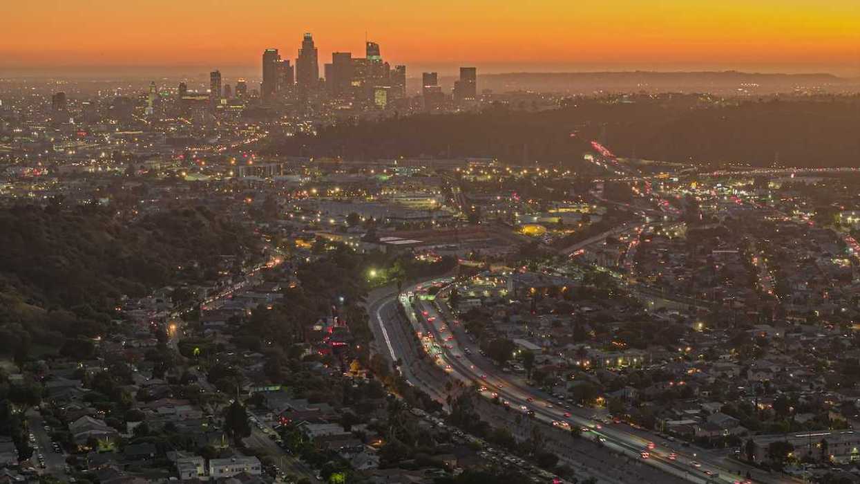 Shot from hilltop, dawn breaks over Los Angeles