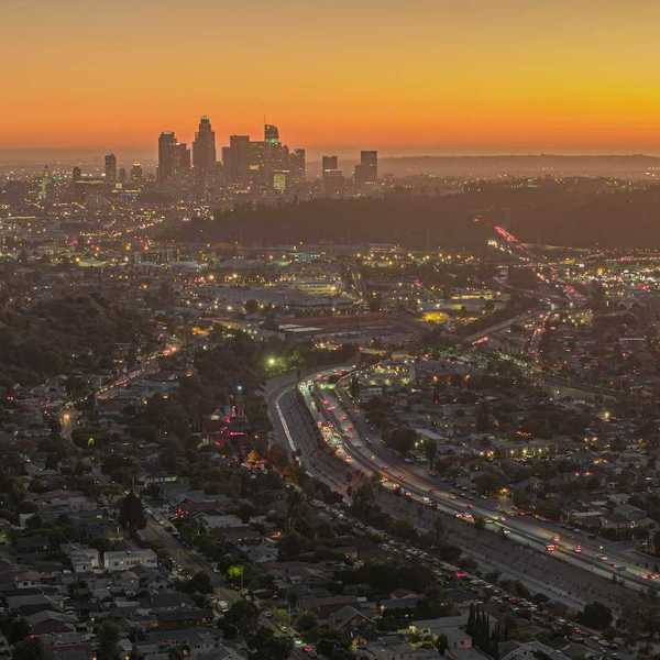 Shot from hilltop, dawn breaks over Los Angeles