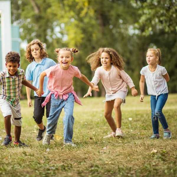 Six children enjoying outdoor open-air play