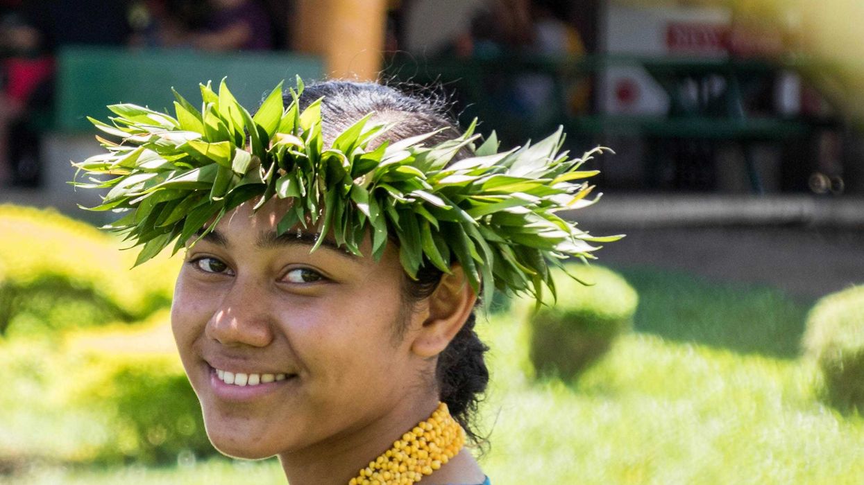smiling woman wearing a crown of green leaves
