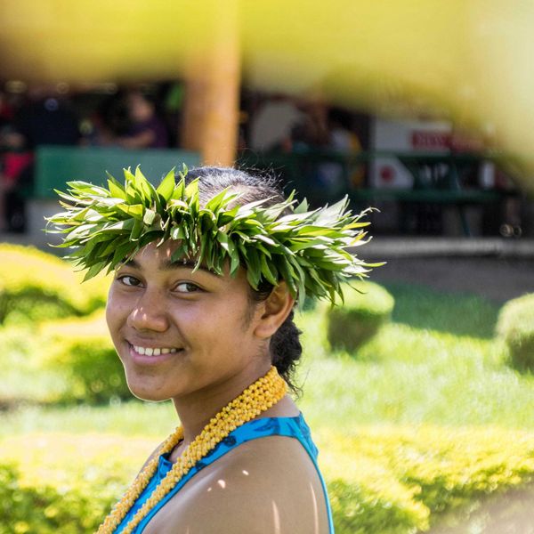 smiling woman wearing a crown of green leaves