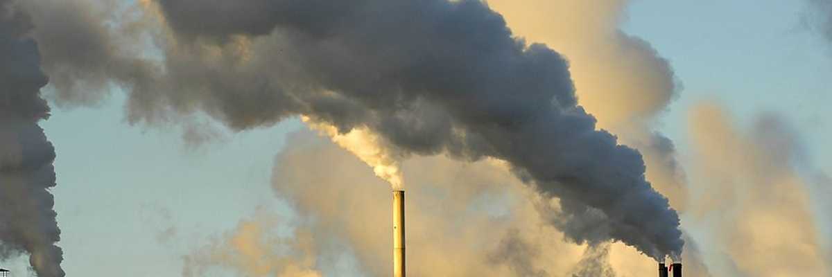 Smokestacks from a factory spewing smoke and pollution into the air.