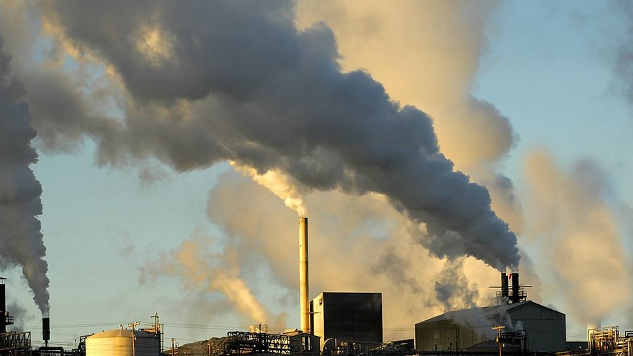 Smokestacks from a factory spewing smoke and pollution into the air.