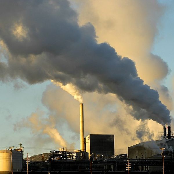 Smokestacks from a factory spewing smoke and pollution into the air.