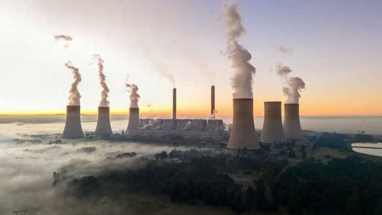 Smokstacks from a power plant emitting smoke into the air