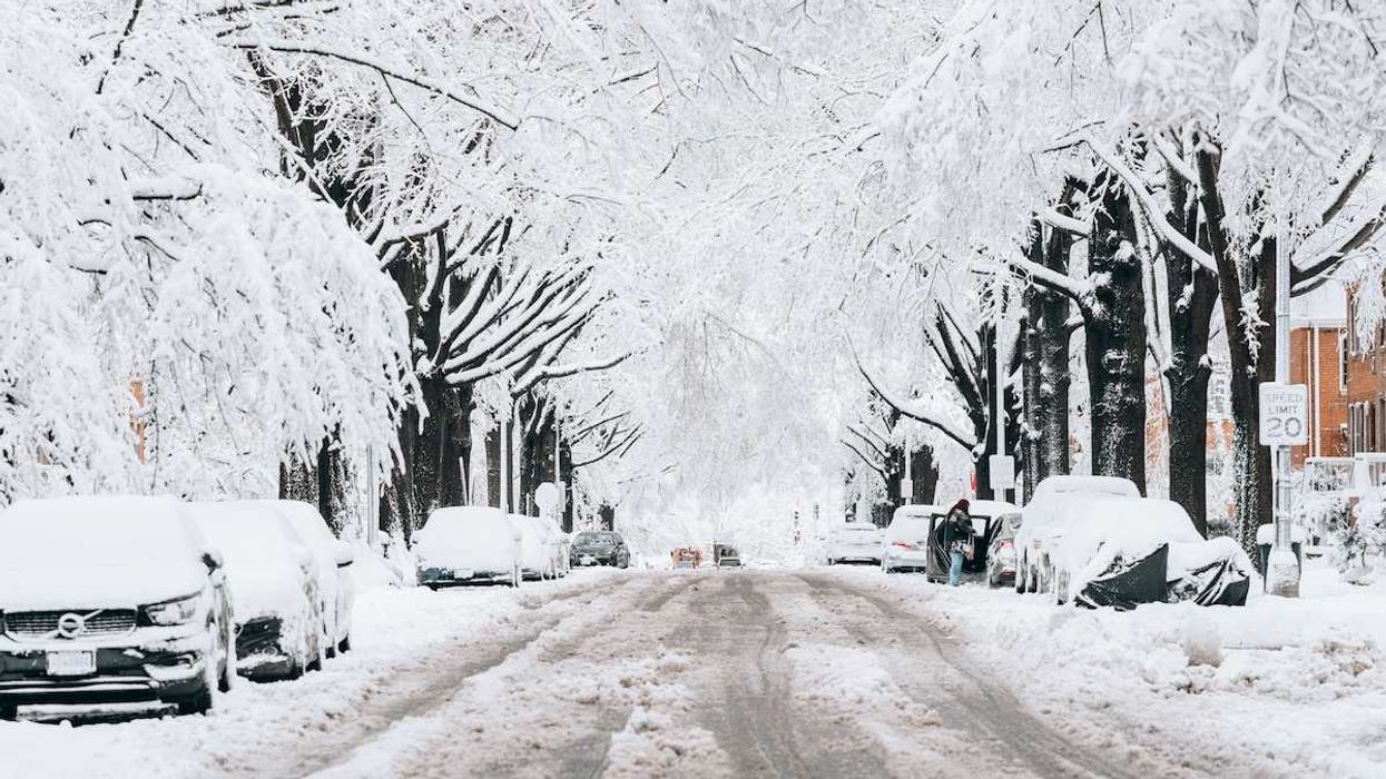 Snowy, slushy street with buried vehicles