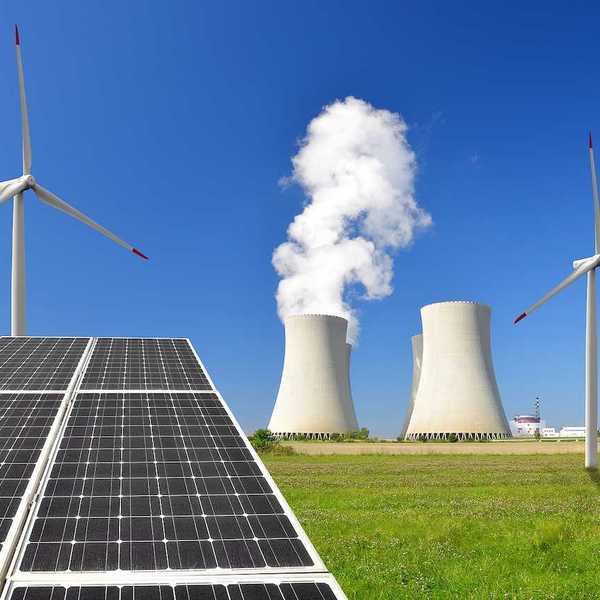 Solar panel, wind turbines and cooling towers from a nuclear power plant