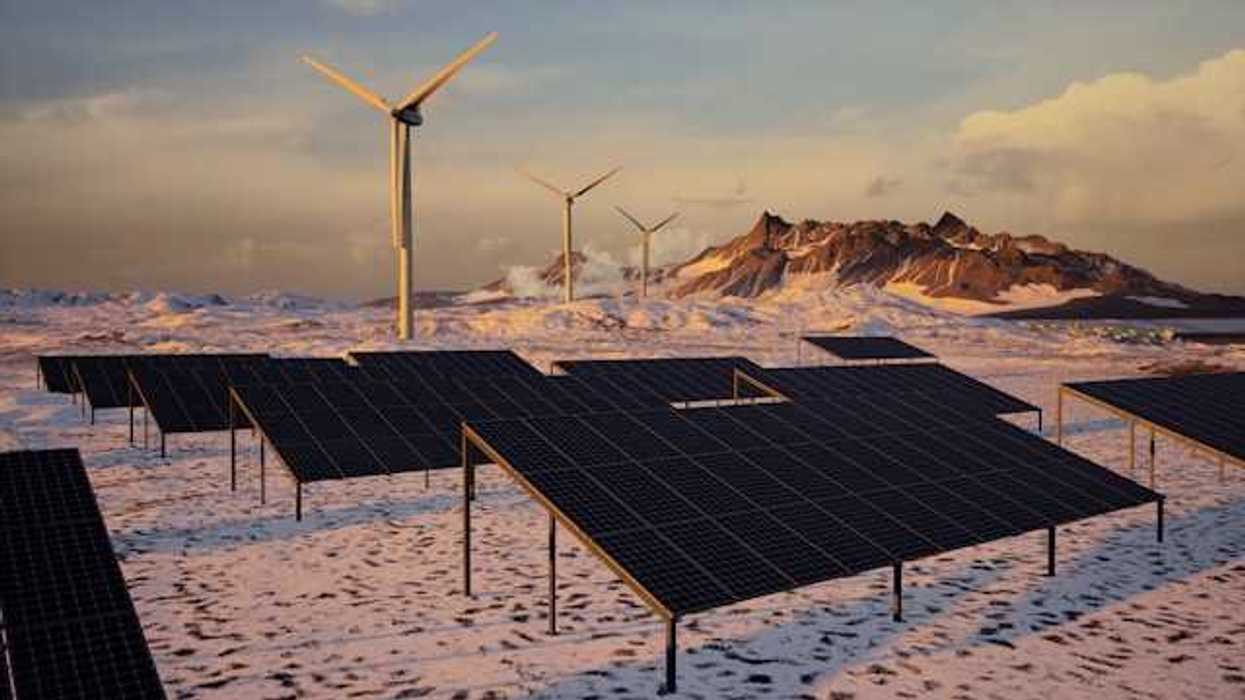 Solar panels and wind turbines in a snowy landscape