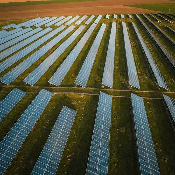 Solar panels arrayed across rural agricultural setting