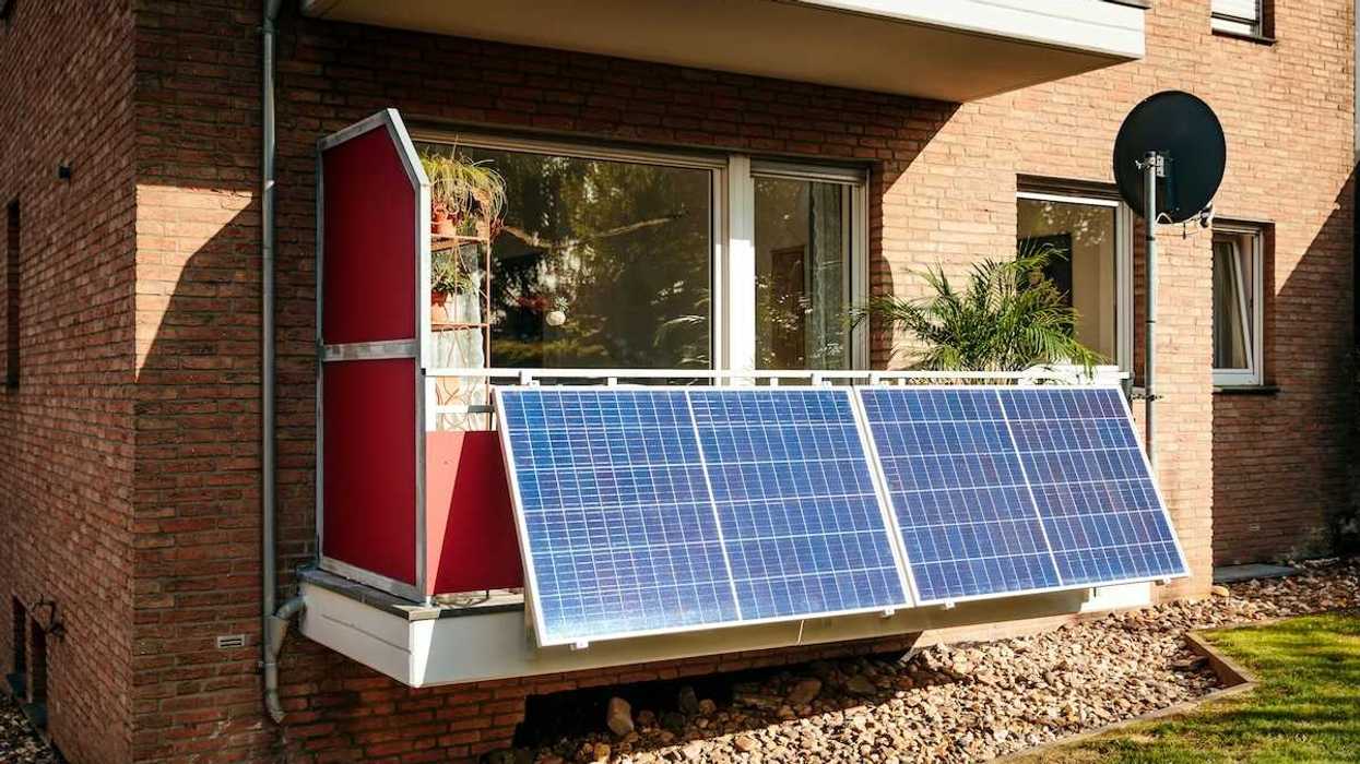Solar panels installed on a city balcony, generating solar energy.