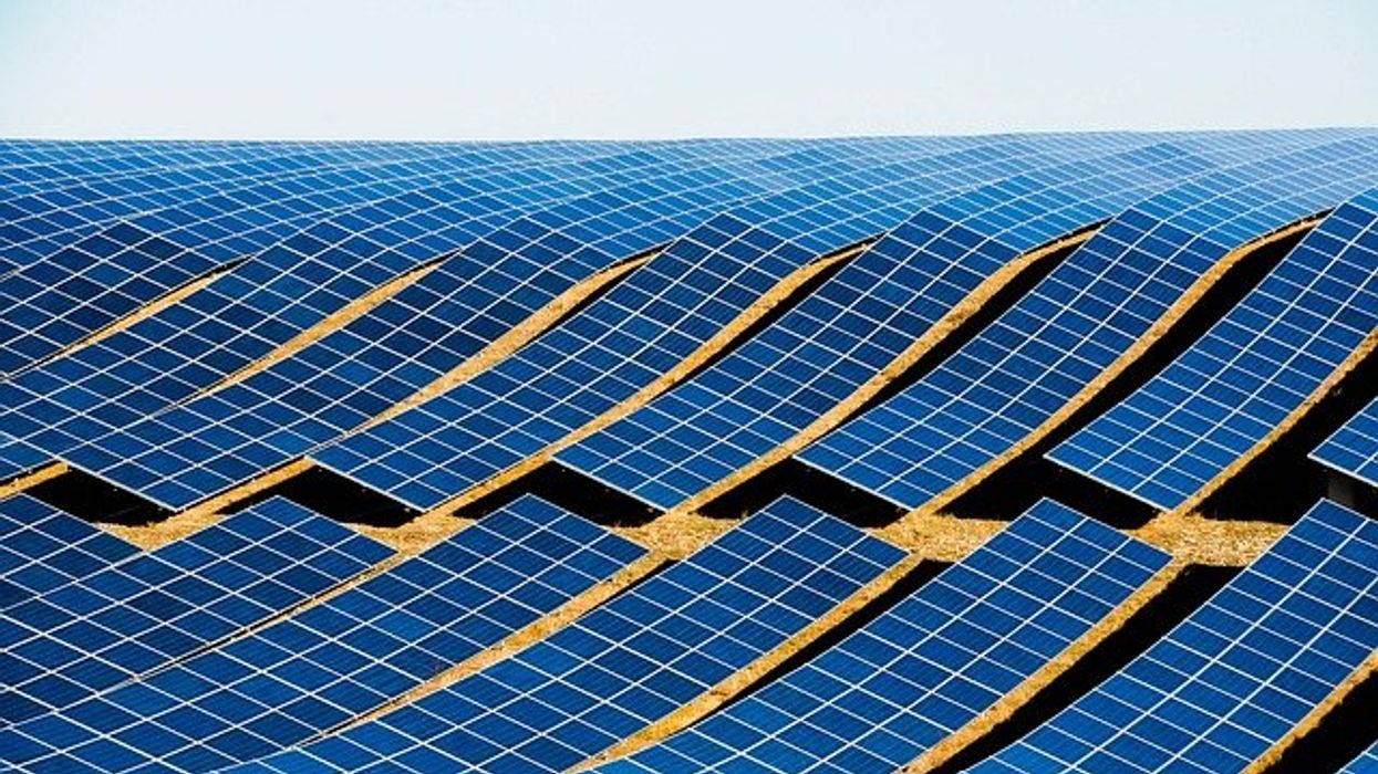 Solar panels installed on a rolling hill.