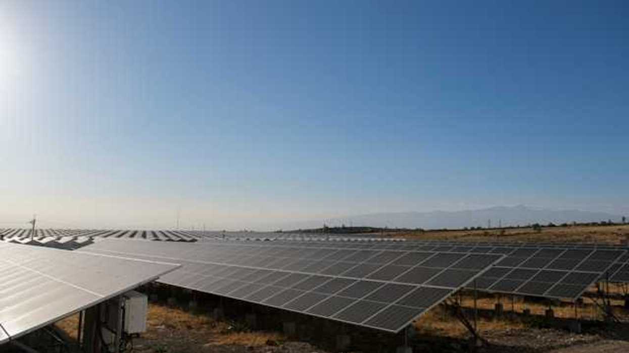 Solar panels stretched across a rocky landscape