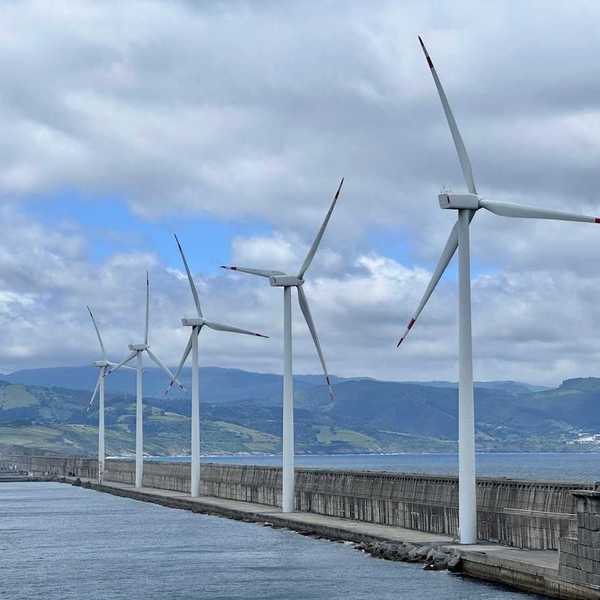 Spanish wind turbines operated by Acciona Energía, on the harbour wall at Bilbao.