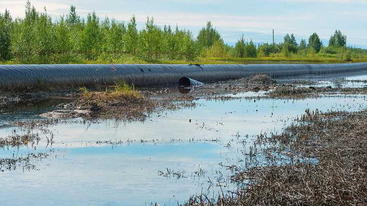 Spilled oil around a leaking oil pipeline.