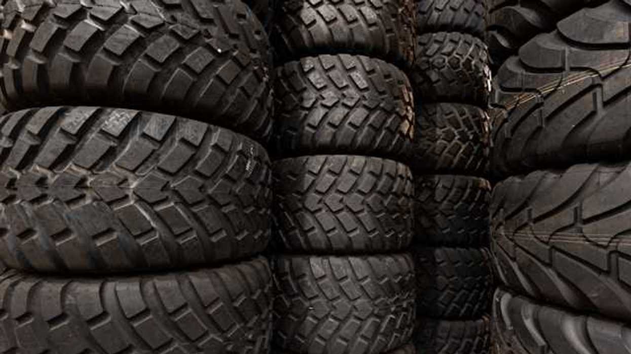 Stacks of car tires with varying tread patterns