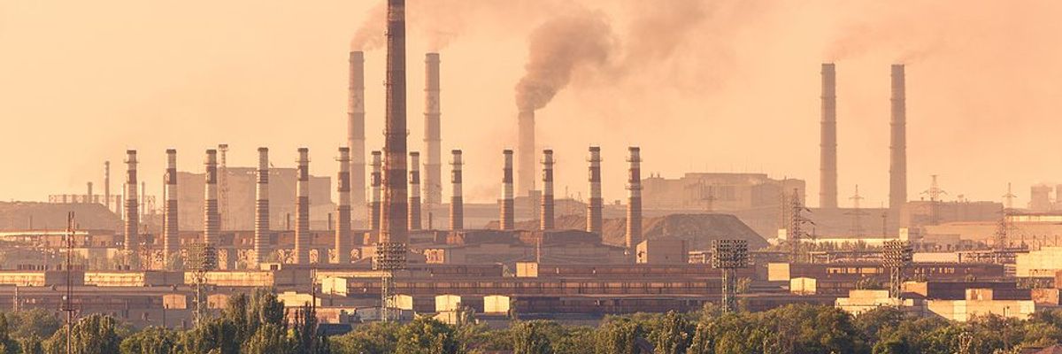 Steel plant in the distance with a town in the foreground.