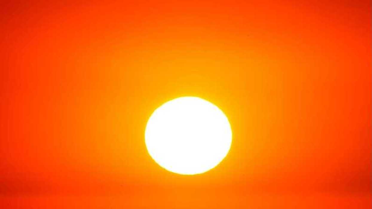 Sun shining through a red, hazy, heatwave