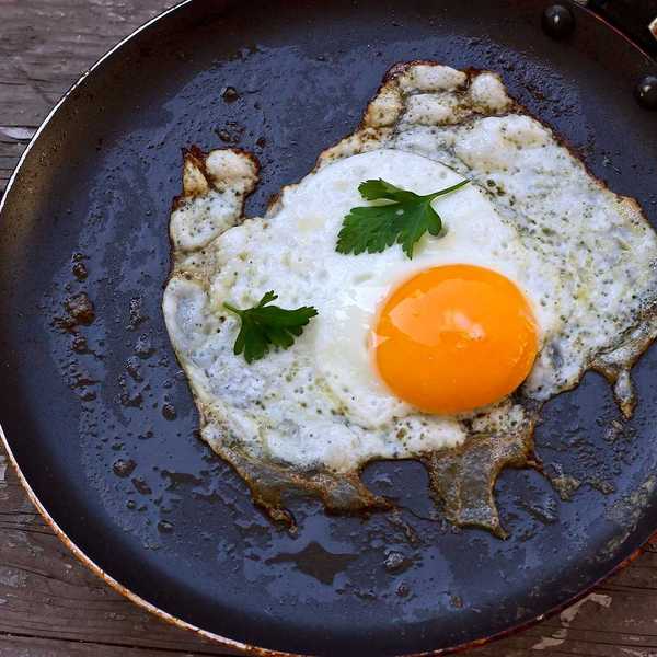 Sunny-side up egg frying in a teflon coated frying pan
