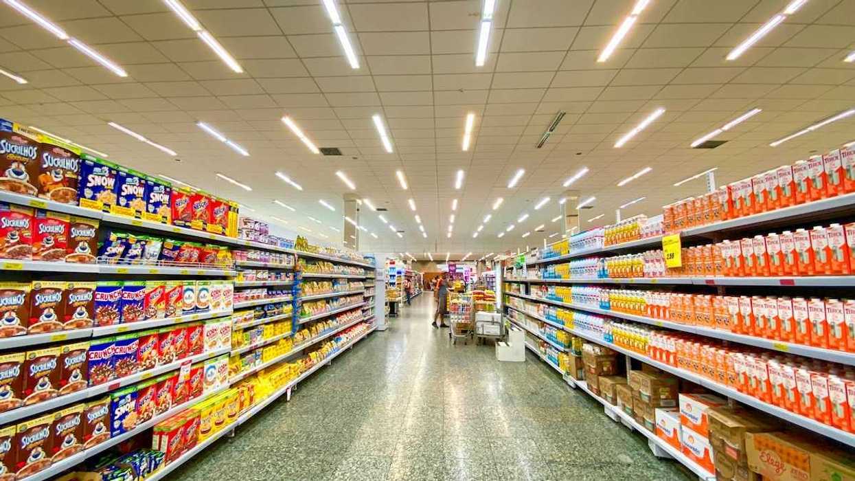 Supermarket aisle lined with mostly packaged, processed food