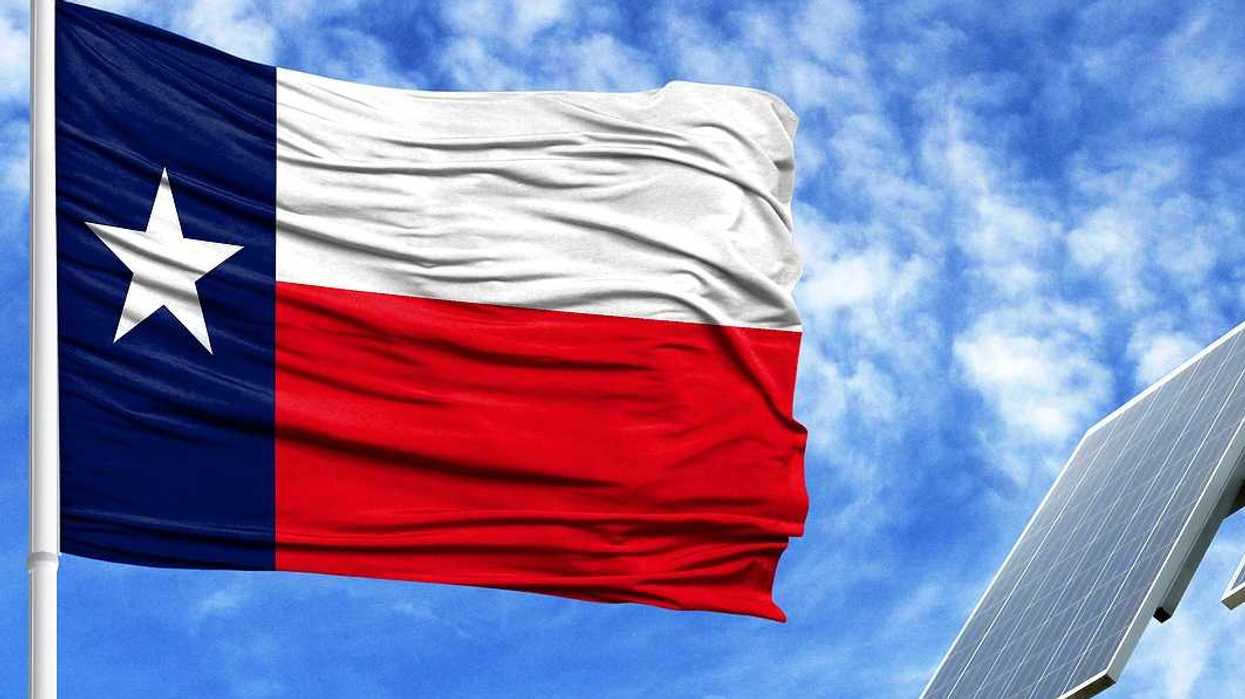 Texas flag flying adjacent to solar panel