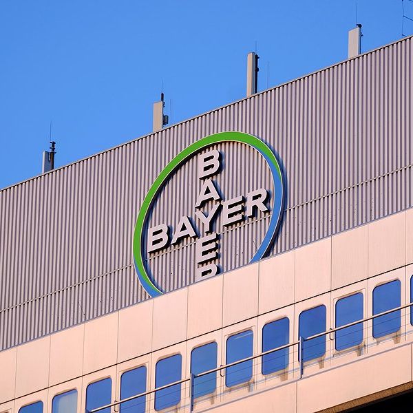 The Bayer logo on the top of a large building.
