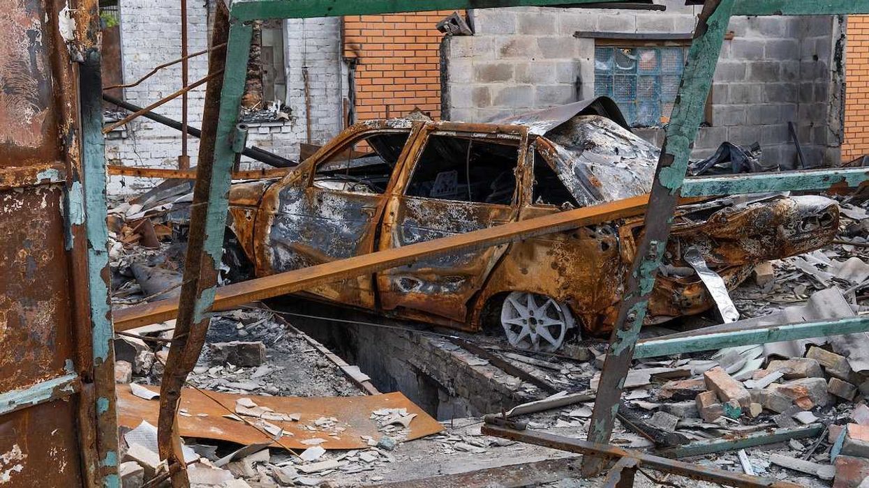 The car burned down in the garage of a house. Explosion and fire in the workshop. Soot and coal around.