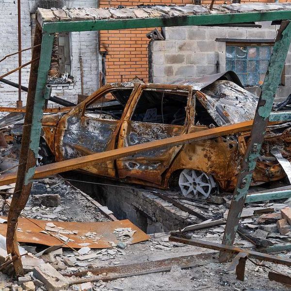 The car burned down in the garage of a house. Explosion and fire in the workshop. Soot and coal around.