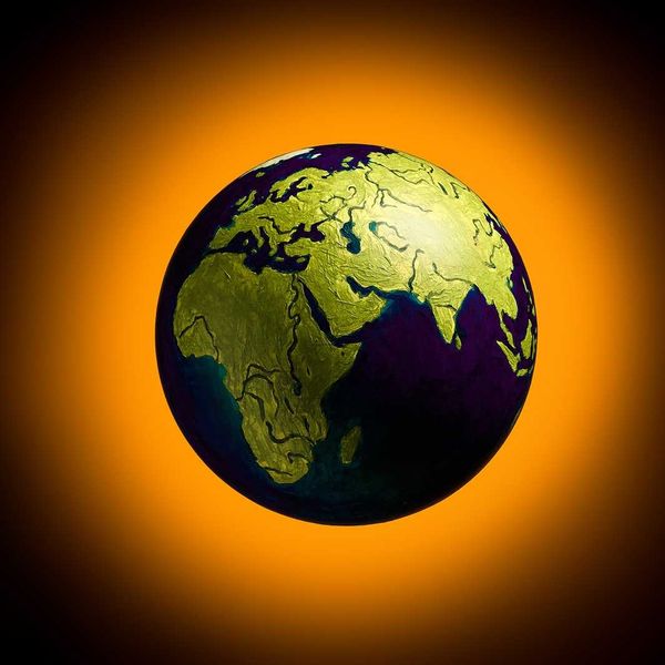 The concept of climate change. Planet earth on fiery orange background.