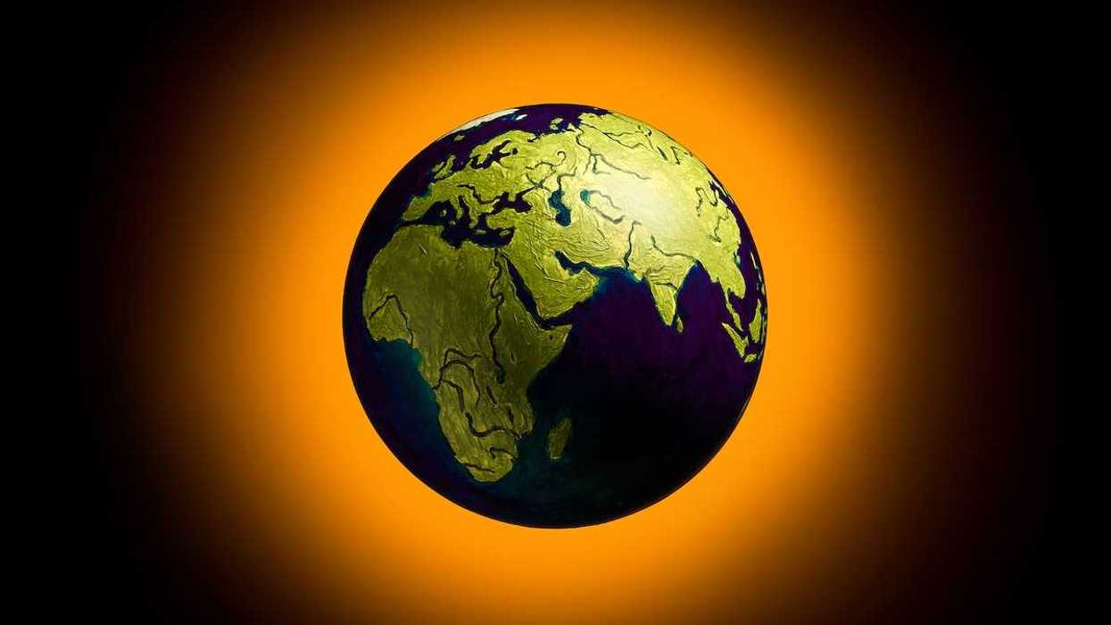 The concept of climate change. Planet earth on fiery orange background.