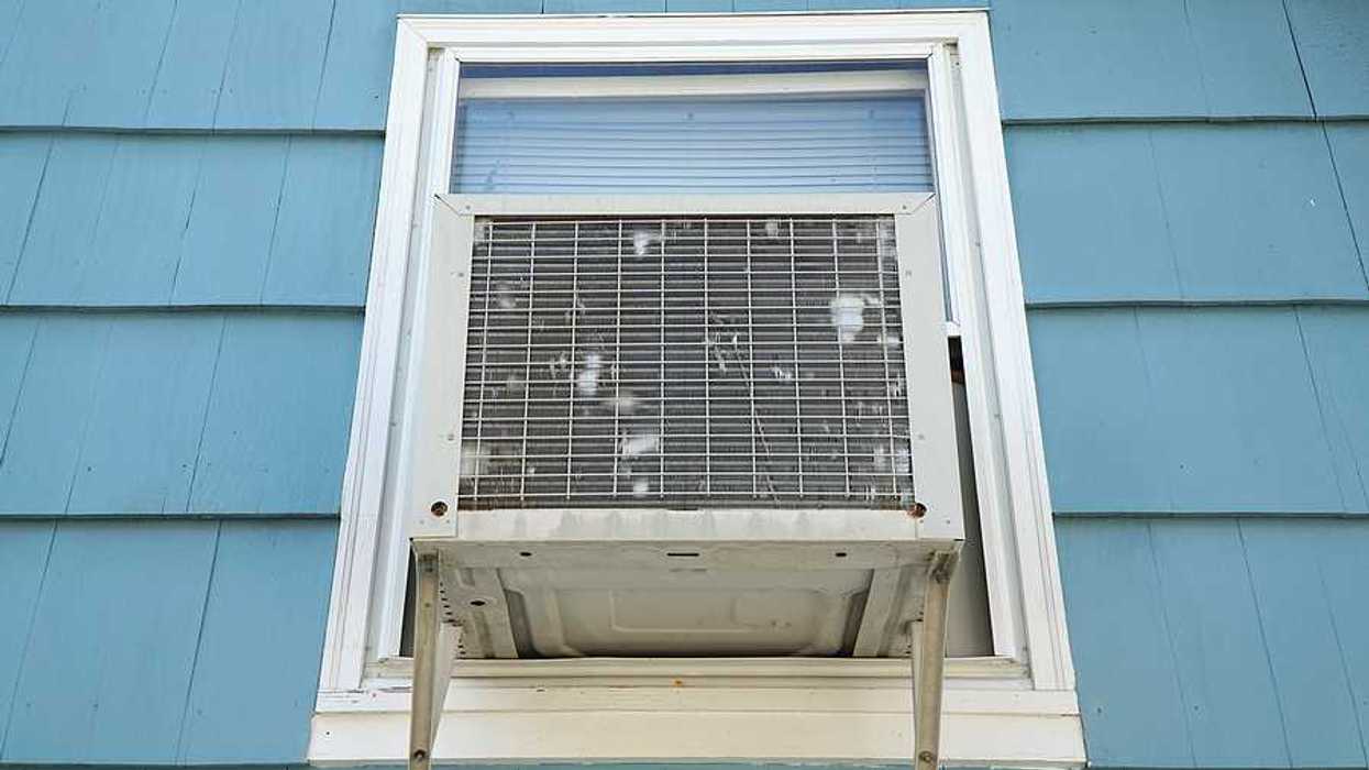 The exterior of a house with a window air conditioner installed
