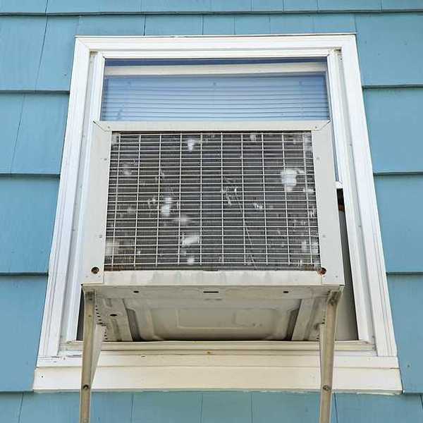 The exterior of a house with a window air conditioner installed