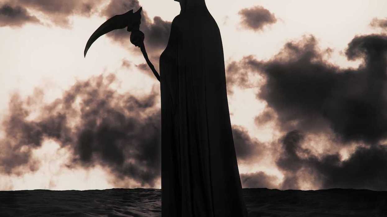 The Grim Reaper silhouetted against apocalyptic background