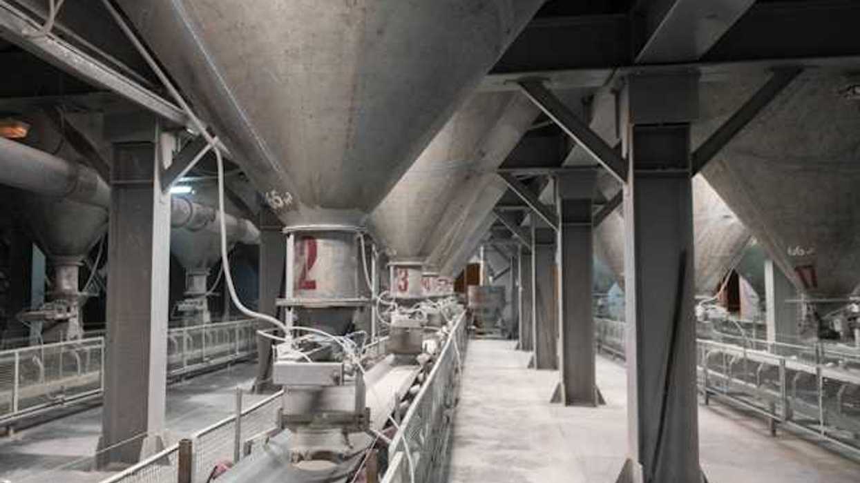 The interior of a cement plant with funnels leading to conveyer belts