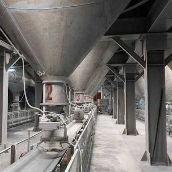 The interior of a cement plant with funnels leading to conveyer belts