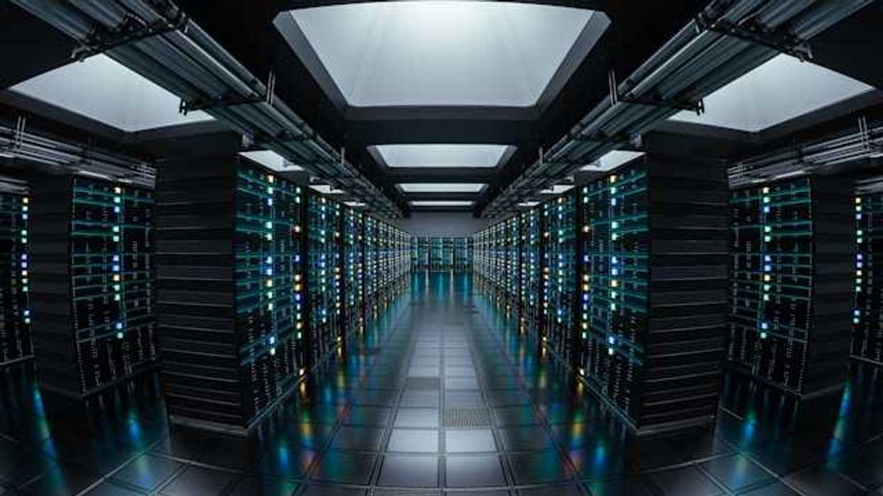 The interior of a data center with rows of black servers stretching into the distance