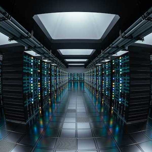 The interior of a data center with rows of black servers stretching into the distance