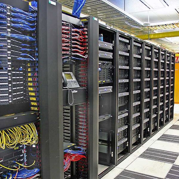 The interior of a data center with rows of computer servers