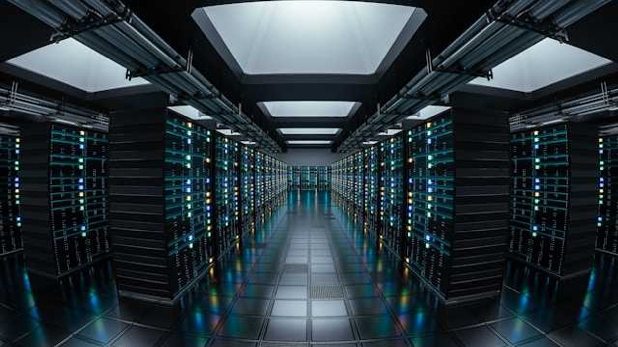 The interior of a data center with rows of servers stretching into the distance