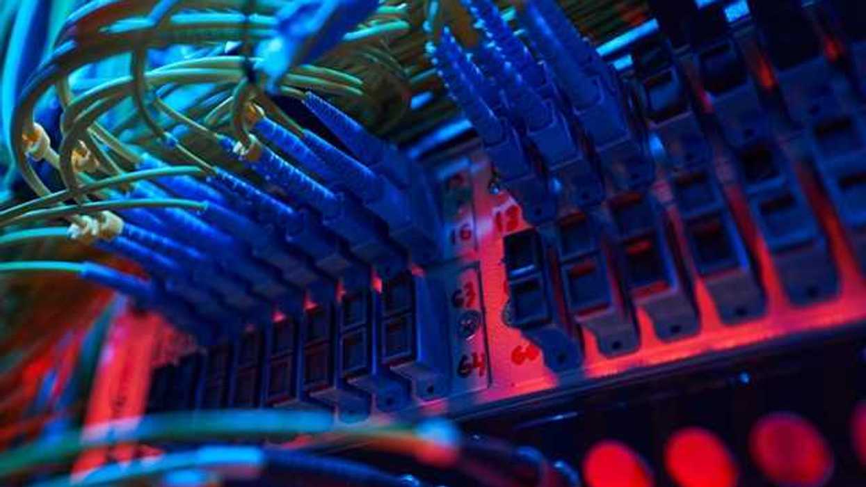The interior of a data server with many wires and red lights