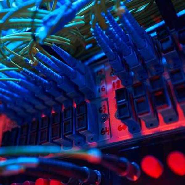 The interior of a data server with many wires and red lights